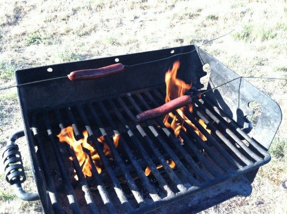 Grilling up some hotdogs.